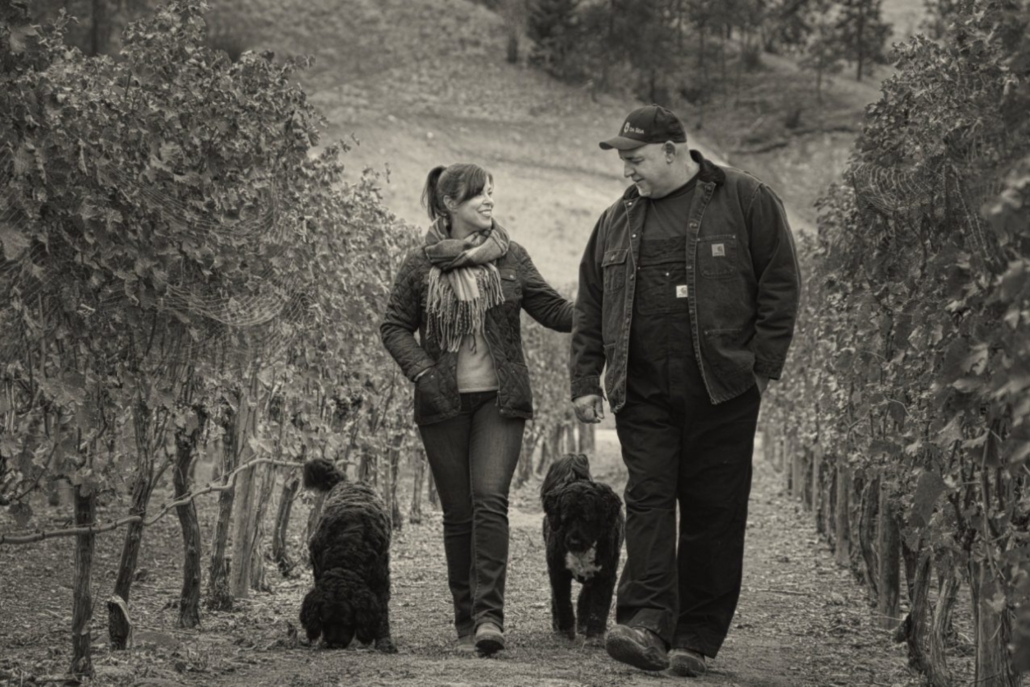 The Da Silva family walking through their vineyard with their two dogs in Naramata.