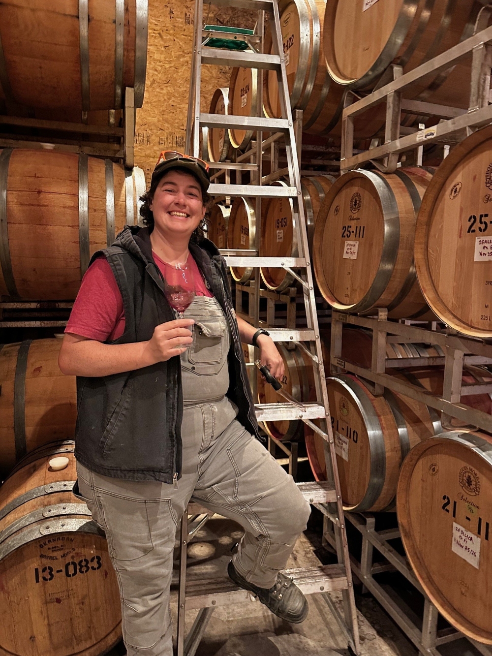 Melissa Smits, Winemaker at Intersection Estate Winery, swirling a glass of wine in the cellar.


